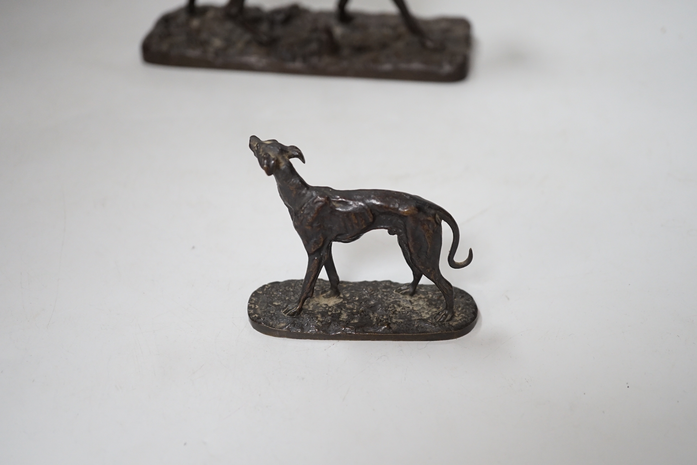 After Pierre-Jules Mêne (1810 – 1879) a patinated cast iron hound and a similar small bronze figure of a greyhound, the largest 18cm wide